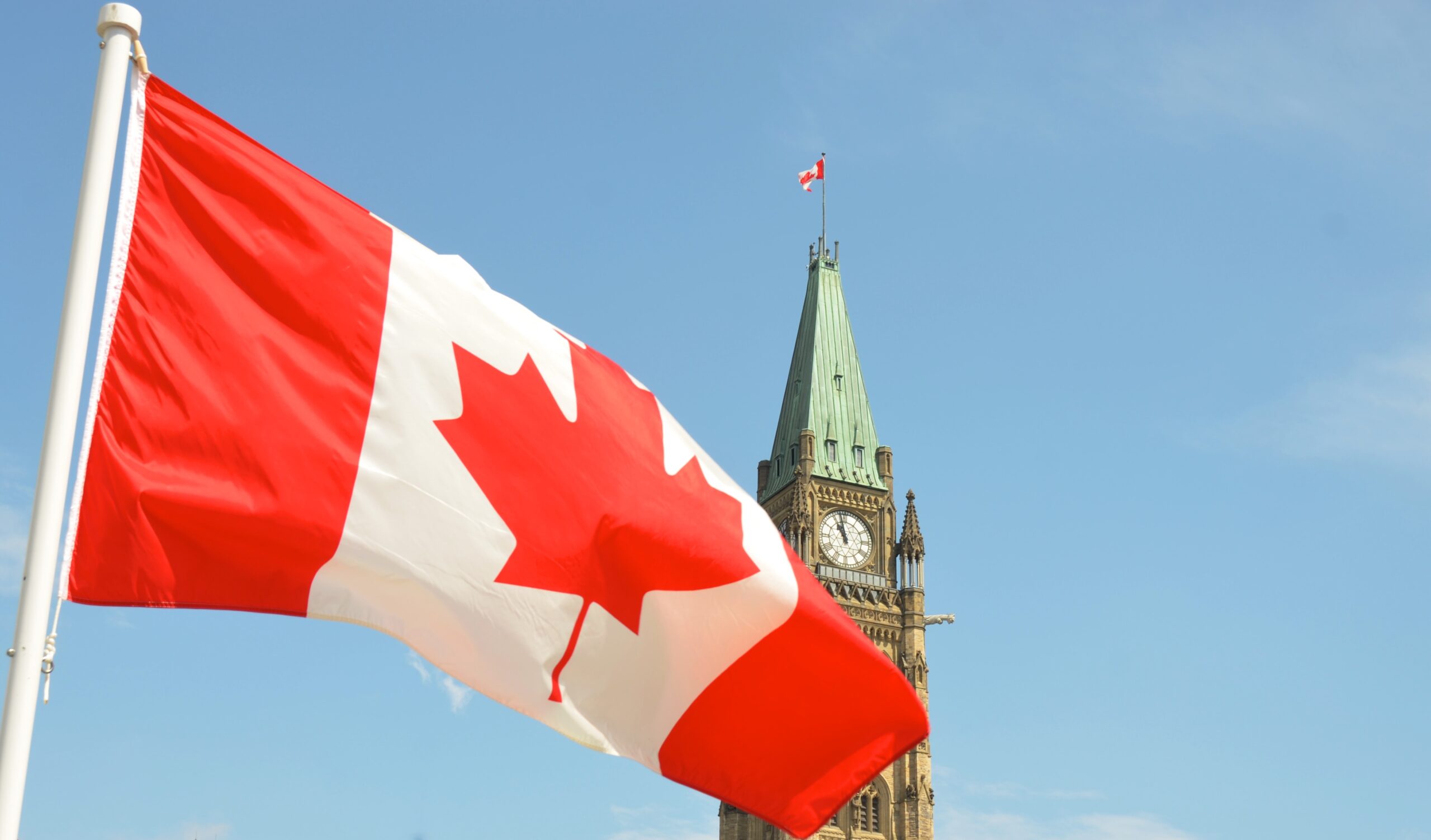 The Canadian flag flying in front of the Peace Tower in Ottawa
