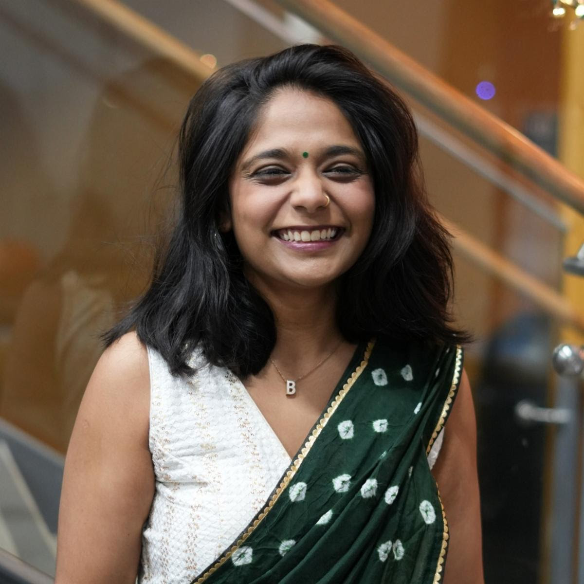A smiling student in a sari at the Diwali celebration on campus