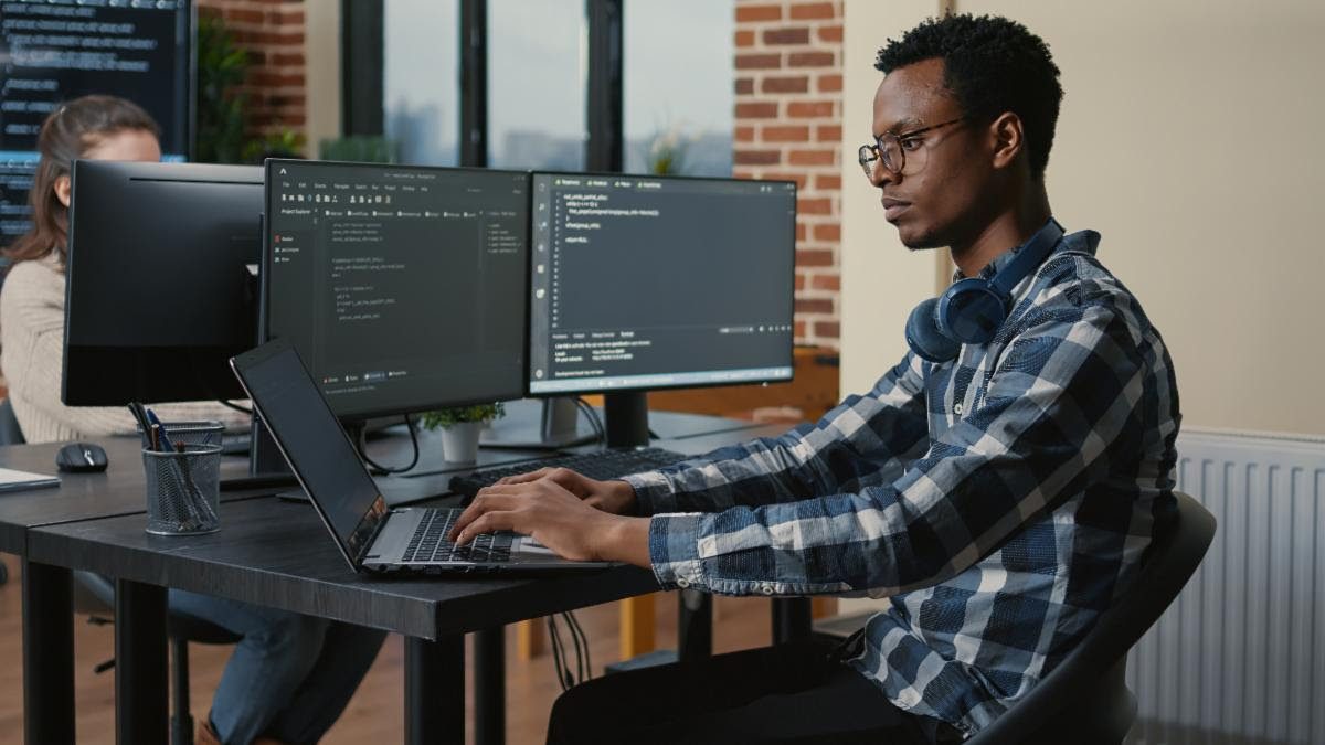 A student working at a computer in the IT diploma program