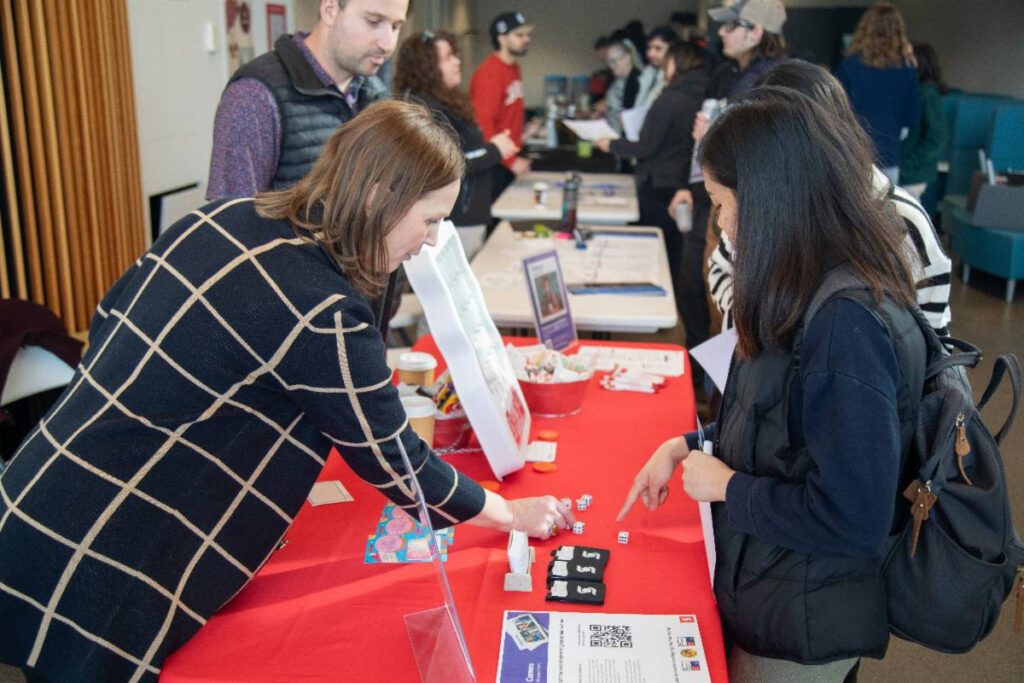 Employers and students talking at a career fair table