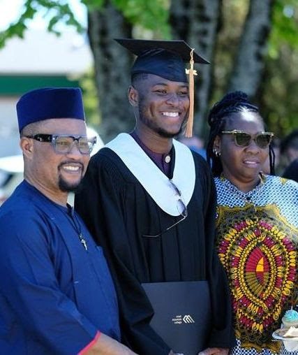 A graduate posing with family after the ceremony