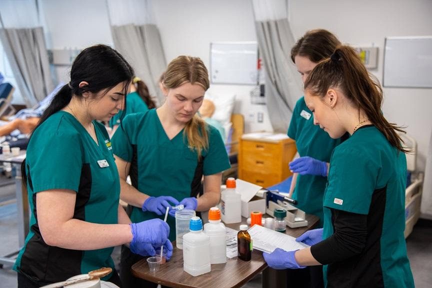 Nursing students practising in a lab at CMTN