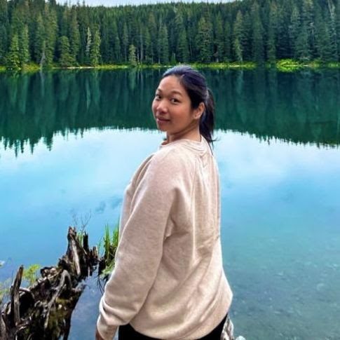 Monica Enah Barro at a mountain lake